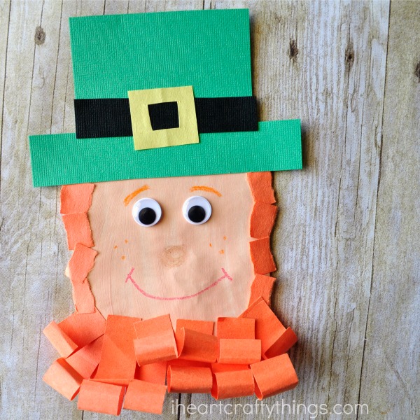Close up image showing how to glue the pieces onto the envelope to make the lephrechaun puppet.