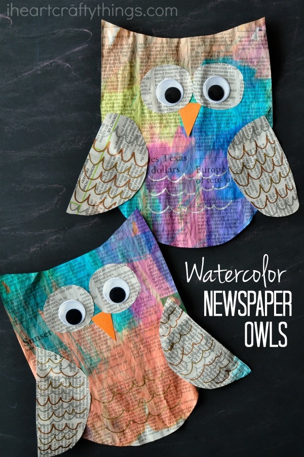 Vertical image of two painted newspaper owl crafts laying one on top of the other with the words "watercolor newspaper owls" in the bottom right corner.