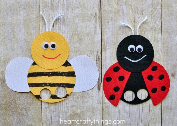 photo of bee finger puppet and ladybug finger puppet laying flat on a faux wood background