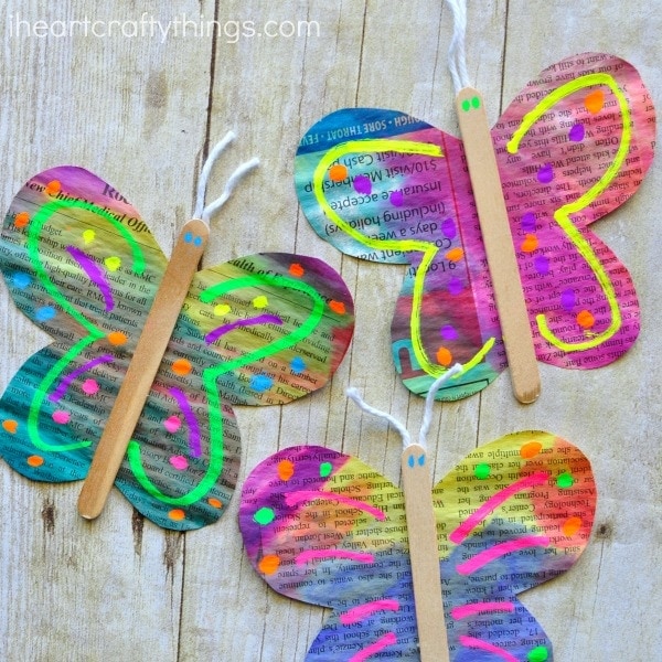 close up image of three painted newspaper butterfly crafts