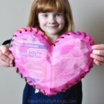 This painted newspaper puffy heart craft is a fun Valentine's Day craft for kids that uses recyclable materials and works fine motor skills.