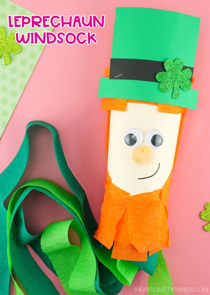 close up of leprechaun windsock laying on pink background