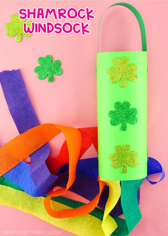 close up of shamrock rainbow windsock craft laying on pink background