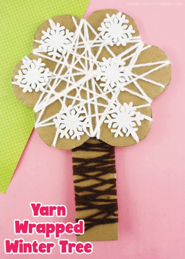 Vertical close up image of yarn wrapped winter craft with the words "Yarn wrapped winter tree" in the bottom left corner.