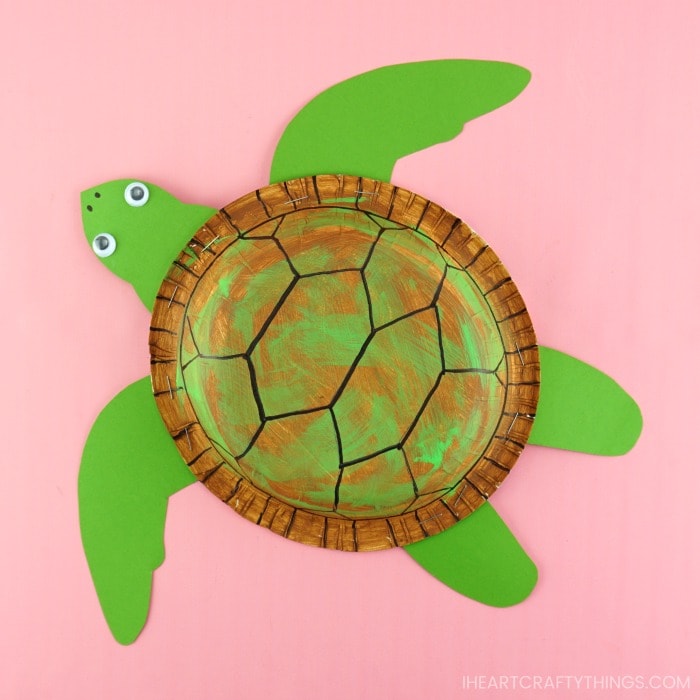 paper bowl sea turtle craft laying flat on a pink background