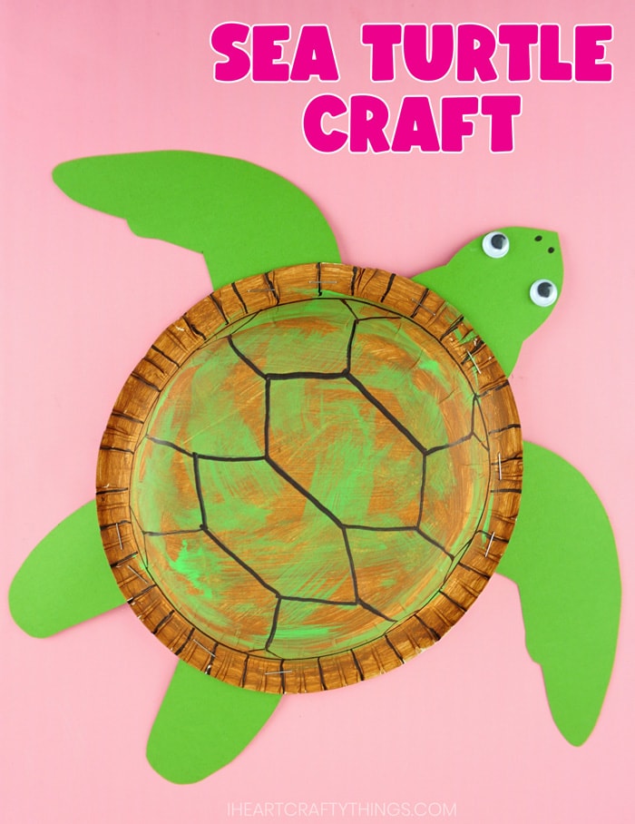 vertical image of finished sea turtle craft on pink background