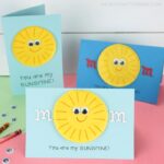Three you are my sunshine Mother's Day cards placed on a pink table with a white shiplap background