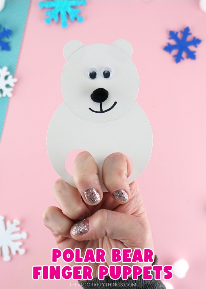 Close up vertical image of adult with their fingers in the polar bear puppets showing how to use it with the words "polar bear finger puppets" on the bottom of the photo.