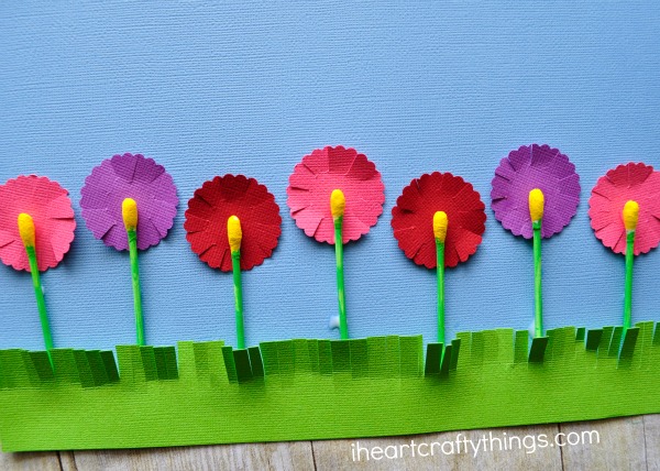 Close up image of how you glue the painted q-tips onto the flower shapes to make flowers.