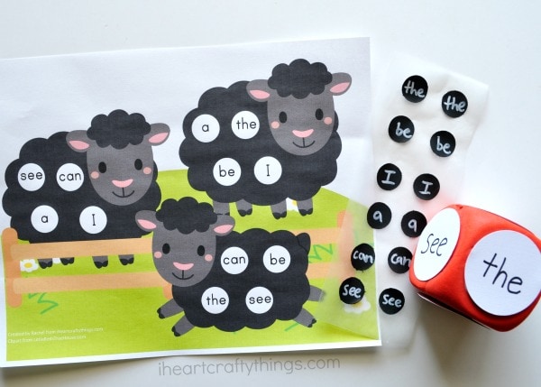 Printable sheep sight words game printed out with word dice and black labels with words on them sitting next to it.