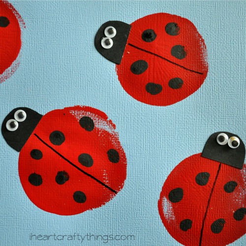 close up image of black fingerprints on balloon printed ladybug craft.