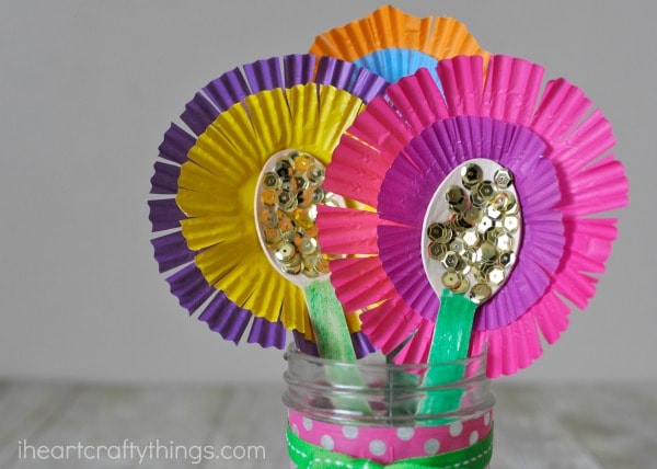 close up image of flower bouquet made out of wooden spoons and cupcake liners.