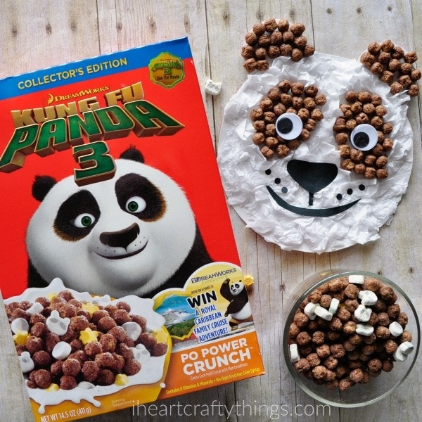 Box of Kung Fu Panda cereal laying next to a bowl of the cereal and a completed panda craft.