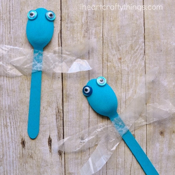 close up image of two wooden spoon dragonflies .