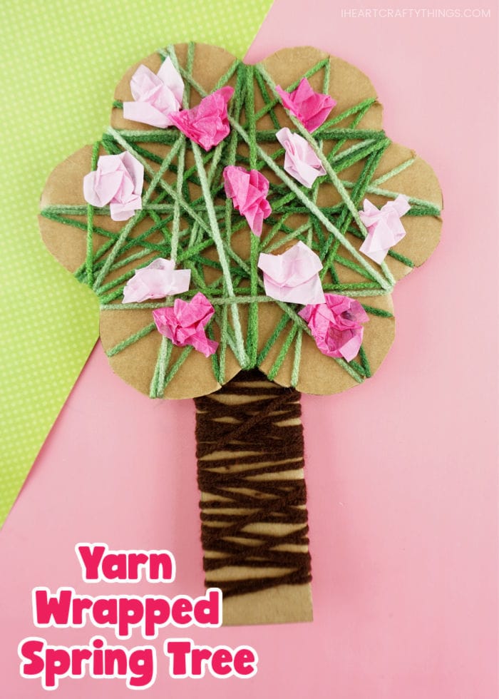 Vertical close up image of yarn wrapped tree craft with the words "Yarn Wrapped Spring Tree" in the bottom left corner.