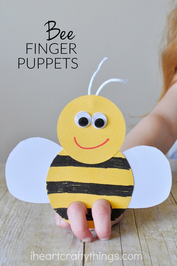 vertical image of child playing with a bee puppet with the words "bee finger puppets" in the top left corner.