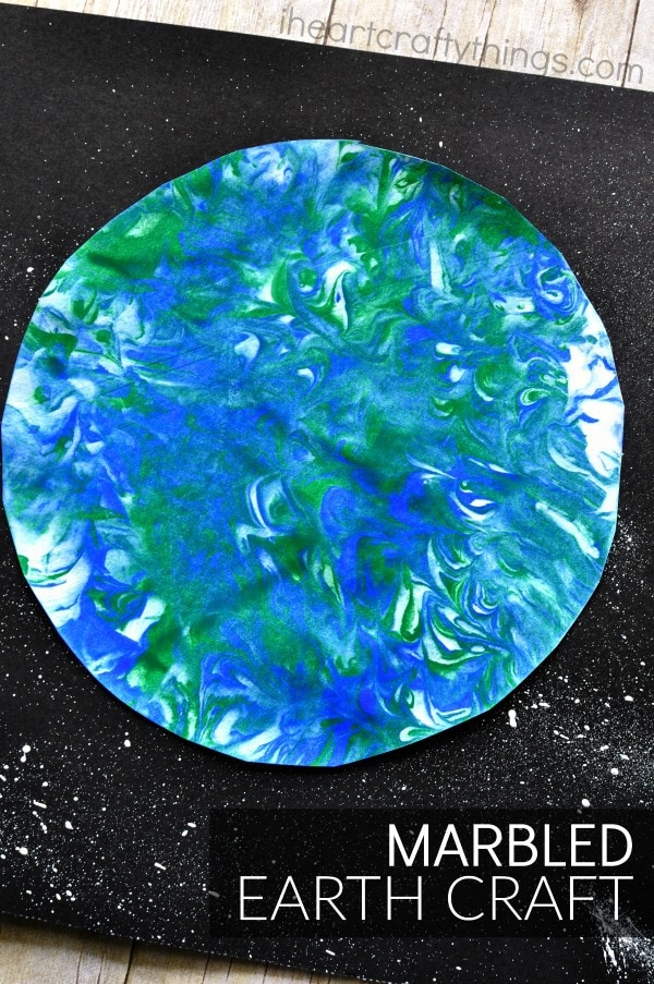 vertical image of finished marbled art earth day craft for kdis