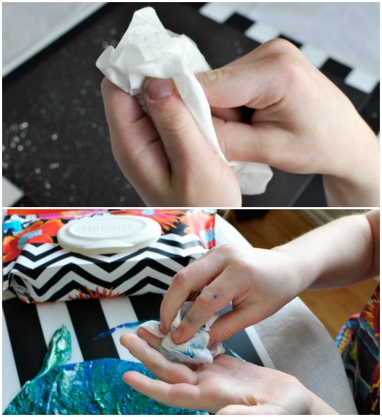 child using Huggies wipe to wipe off their hands after making their marbled art project