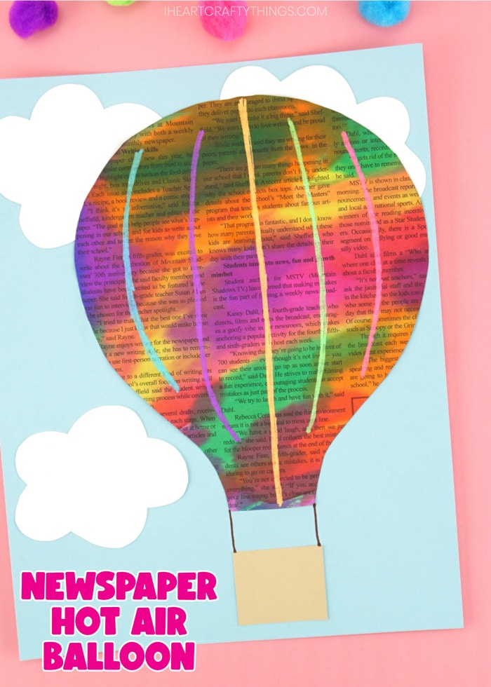 Close up vertical image of finished craft on a pink background with the words "newspaper hot air balloon" in the bottom left corner.