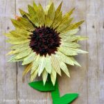 This painted newspaper sunflower craft is perfect for a summer kids craft. Watercolor painted newspaper brings great texture and vibrant colors to crafts. Great kids craft made from recyclables, flower craft for kids, and paper plate kids craft.
