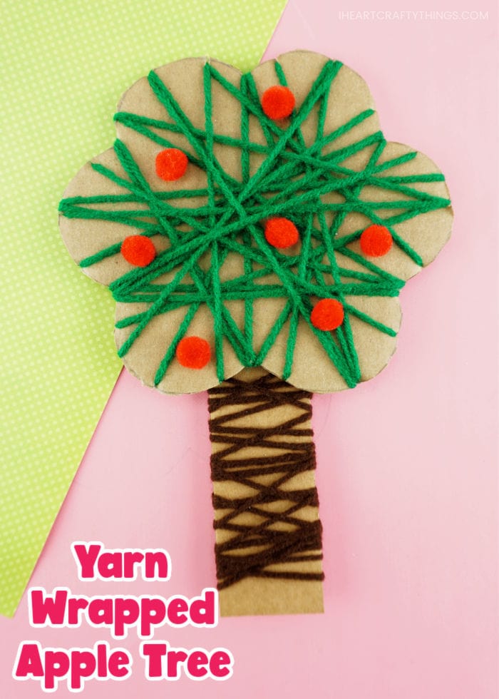 Vertical close up image of apple tree craft with the words "Yarn wrapped apple tree" in the bottom left corner.