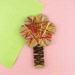Square image of yarn wrapped fall tree craft for preschoolers.