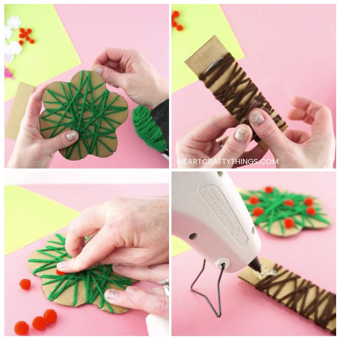 Four image collage showing adult wrapping the cardboard tree with green yarn, then wrapping the tree trunk with brown yarn, gluing red poms for apples on the tree and then hot gluing the tree top onto the tree trunk.