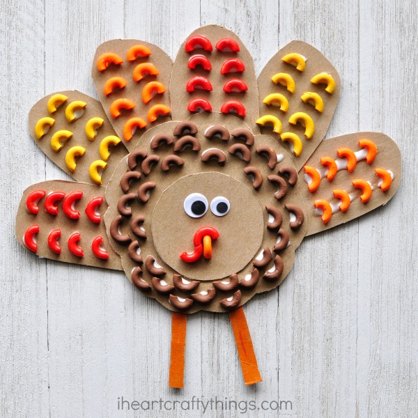 Mimic the texture of bird feathers with pasta and create this awesome elbow macaroni turkey craft. Fun Thanksgiving kids craft.