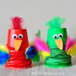 This colorful paper cup parrot craft makes a fun kids craft, bird craft for kids, upcycled kids craft, and preschool craft.