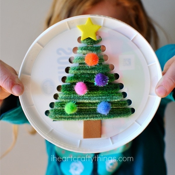 This plastic lid Christmas tree sewing craft is festive, cute and is awesome for a fine motor activity for kids. Fun Christmas craft for kids.