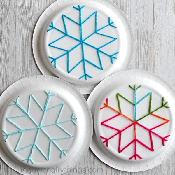 This paper plate snowflake yarn art is a perfect activity for the winter months and is great for beginning sewing and fine motor skills.