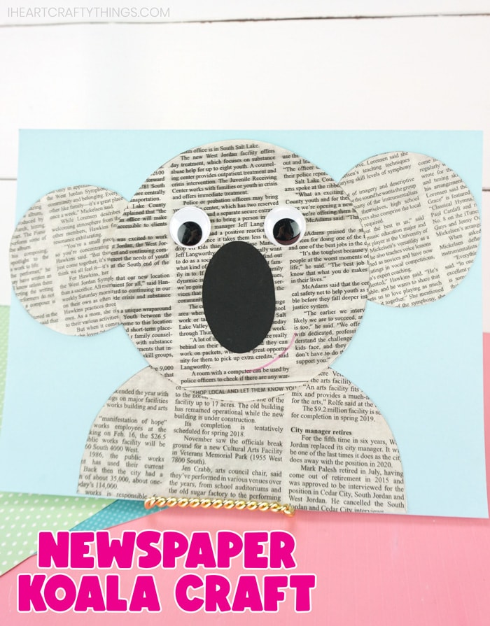 vertical image of completed koala craft propped up on a pink table with a white shiplap background with the words "newspaper koala craft" at the bottom in pink text.