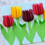 This colorful paper tulip flower craft makes a great spring kids craft or spring flower craft for kids. It also makes a great Mother's Day craft for kids. This pretty flower craft is easy to make and you will love how the 3D paper tulips and folded stems pop off the page.