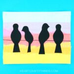 Learn how simple it is to create this birds on a wire art project. Yellow, orange, pink and blue tissue paper is layered to achieve a sunset background and the addition of the black bird silhouette's help the sunset colors pop off the page. Gorgeous bird art project for kids and silhouette art project for kids.