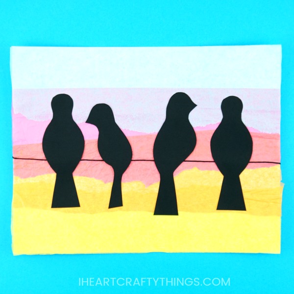 Learn how simple it is to create this birds on a wire art project. Yellow, orange, pink and blue tissue paper is layered to achieve a sunset background and the addition of the black bird silhouette's help the sunset colors pop off the page. Gorgeous bird art project for kids and silhouette art project for kids.