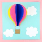 Use our free template to create this gorgeous paper hot air balloon craft. Fun 3D paper craft and summer craft for preschoolers and kids of all ages.
