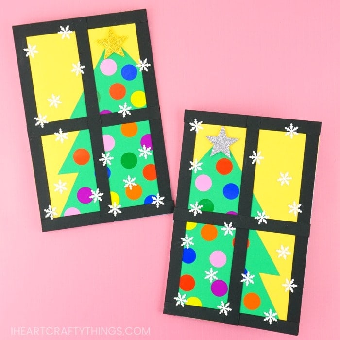 Homemade Christmas tree cards laying on a pink background