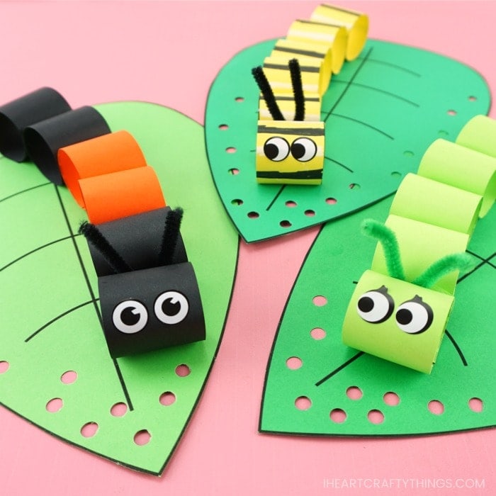 square image of three caterpillar crafts laying on a pink background