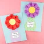 two mother's day flower vase crafts laying flat on a pink background