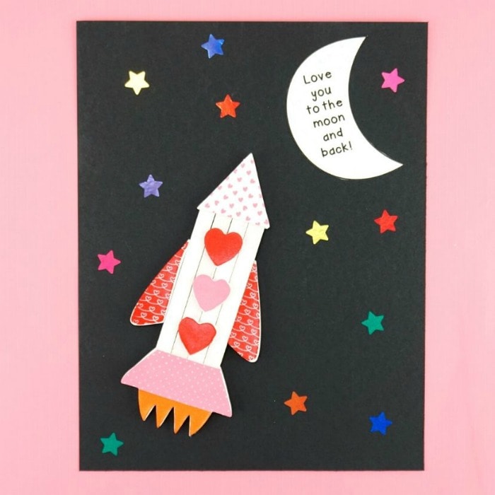 rocket ship Valentine's Day craft laying flat on a pink background