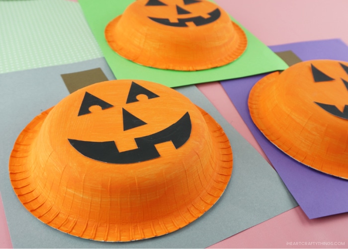 Close up image of paper bowl pumpkin craft taken from an angle that shows the bowl popping off the cardstock paper.