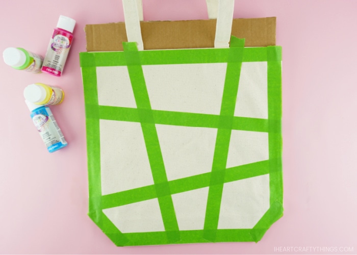 Example of how to place the painters tape on the front of the canvas bag to make geometric painted shapes.