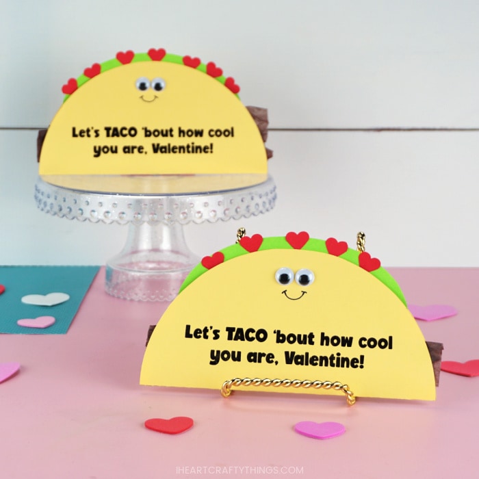 Image showing to taco Valentine's Day cards propped up with one in focus in the front and one out of focus in the back.