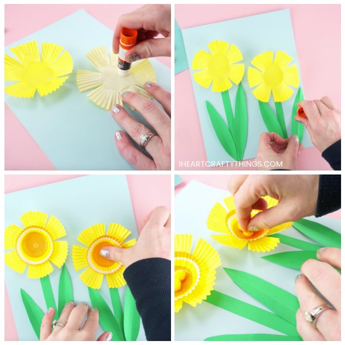 Four image collage showing how to glue the yellow cupcake liners and green stem and leaves onto the blue cardstock paper, and how to glue the mini cupcake liners and small yellow poms on the inside of the flower.