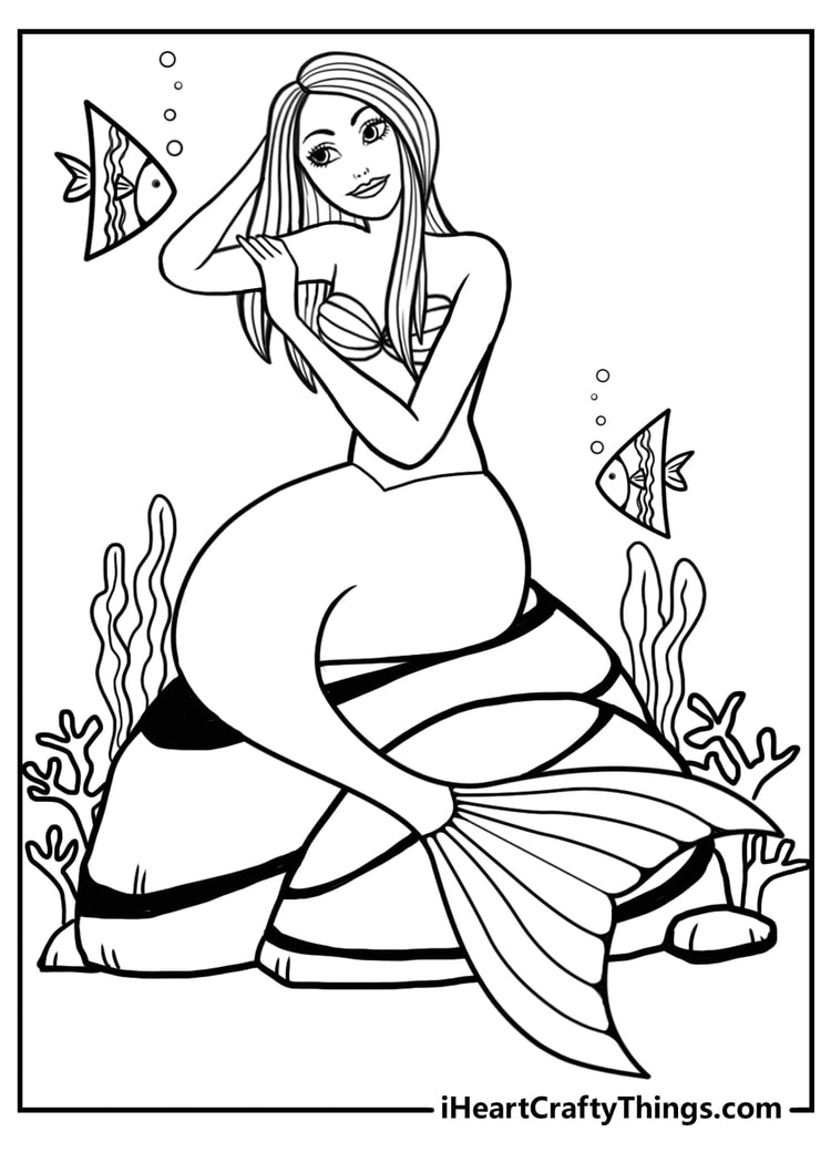 Detailed coloring pdf depicting two triangular fish swimming past a mermaid sitting on stripy rocks