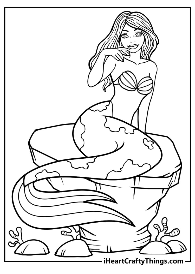 Detailed coloring sheet presenting mermaid with cool patterned tail sitting on a big rock