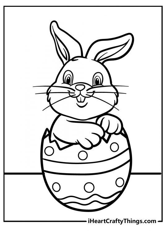 Happily smiling Easter Bunny hatching from an Easter egg free page to download and color