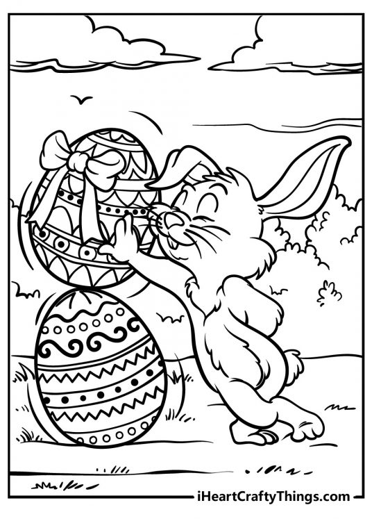 Coloring printable featuring outdoors scene of an Easter Bunny posing as he leans on a tower of giant eggs