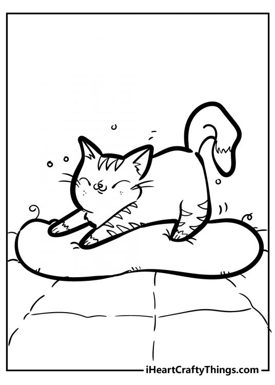 Black-and-white picture for kids featuring happy kitten stretching in her little bed after a nap
