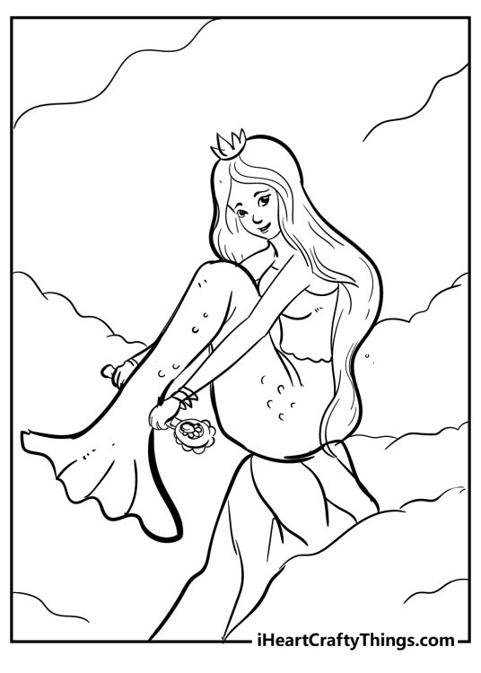 Free printable pdf presenting a mermaid sitting on a rock with a wand in her hands